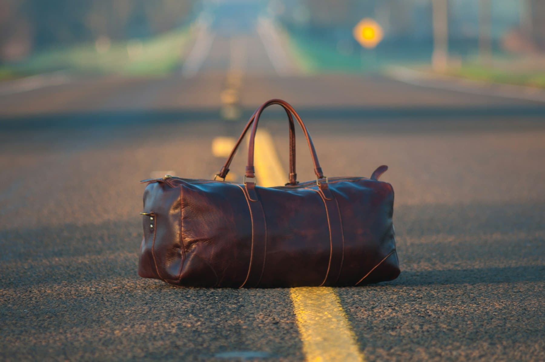 Leather duffel bag on the open road